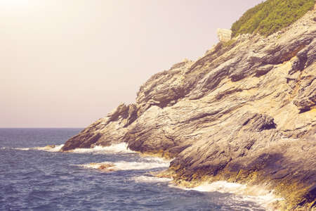 Rocks in the sea in the sunlight. Toned.の写真素材
