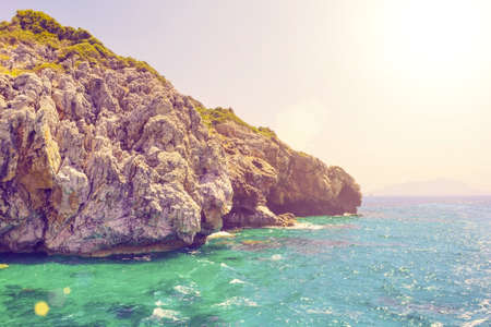 Rocks in the sea in the sunlight. Toned.の写真素材