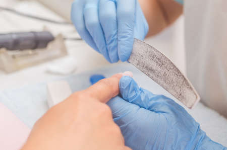 The master prepares the nails for manicure.の写真素材