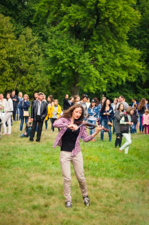 24 august 2017 Ukraine, White Church. Young girl playing the violin in nature.