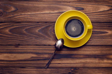 Cup of coffee on wooden table top view.の写真素材