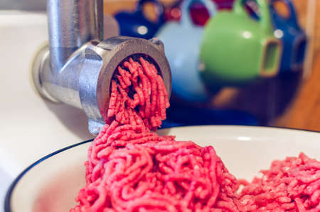 Process of preparation of a minced meat by means of an electric meat grinder.の写真素材
