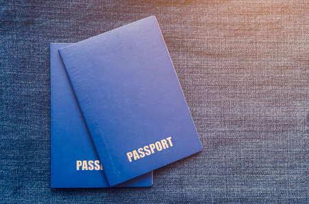 Two blue passports on a blue background.の写真素材