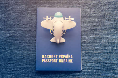 A small toy plane over the blue Ukrainian passport.
