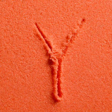 Letter Y written on orange sand.の写真素材