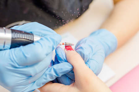 Manicure process, cleaning of nails by a milling cutter.