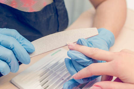 The master prepares the nails for manicure.の写真素材