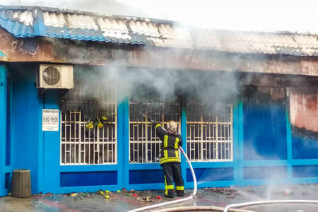 Belaya Tserkov, Ukraine, May 8, 2018: The burning of a shop on the city street. Extinguishing the fireのeditorial素材
