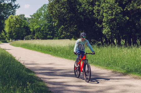 The cyclist in motion riding bicycle road.