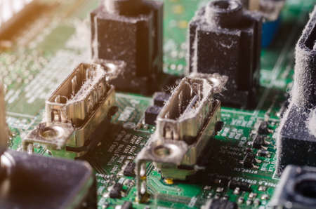 A thick layer of dust covers the internal electronic components of the computer.の写真素材