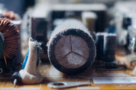 A thick layer of dust covers the internal electronic components of the computer.