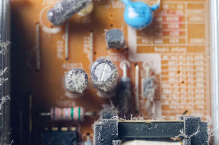 A thick layer of dust covers the internal electronic components of the computer.