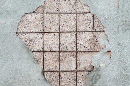 A broken plaster on a concrete wall, background texture.の写真素材
