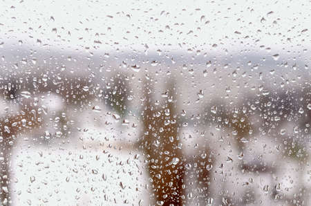 Drops of rain or sleet on the window in winter.の写真素材