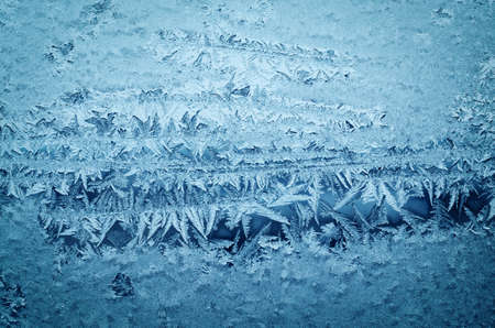 Abstract frosty pattern on glass, background texture.の写真素材