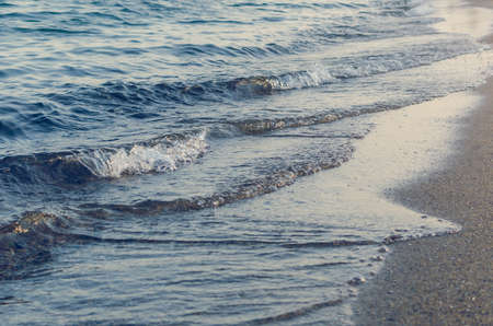 Waves of the sea on a sandy beach.の写真素材