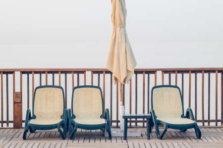 Swimming pool near the hotel with sun lounger and umbrella.の写真素材