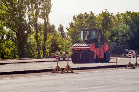 Road works, compaction of the pavement using an asphalt roller.