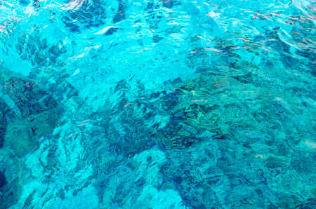 Colorful ripples of the water surface in the Red Sea overlooking the coral at the bottom.