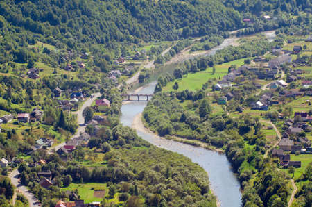 Ukraine Carpathians, a settlement in a valley of mountains, beautiful landscape aerial view.
