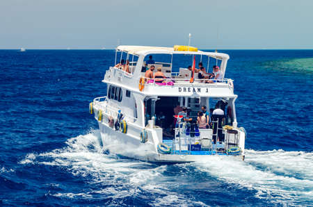Sharm El Sheikh, Egypt May 08, 2019: Pleasure tourist boat with passengers sailing in the clear blue...