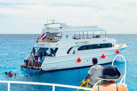 Sharm El Sheikh, Egypt May 08, 2019:Pleasure cruise ship stands near the coral reef, people swim in...