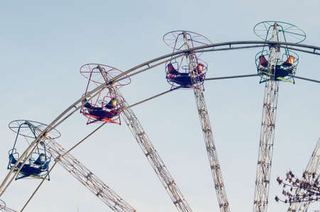Old ferris wheel in a city park against the sky.の写真素材