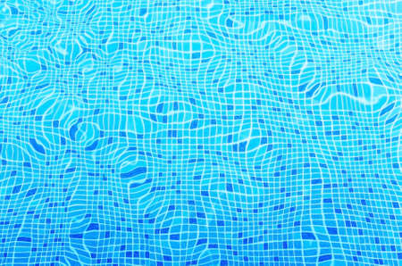 Ripples on the surface of the water in a blue swimming pool.
