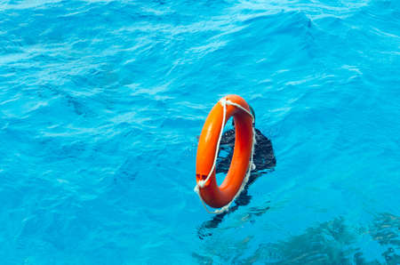 A lifebuoy is thrown into the water of a drowning person.の写真素材