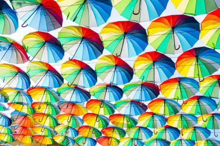 Hanging multicolored colorful umbrellas adorn the alley, street decoration.