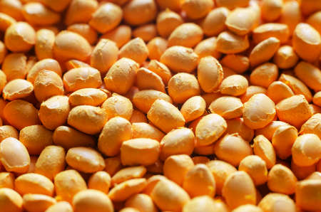 Orange polymer dye in granules, background texture.