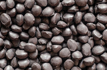 Black polymer dye in granules, background texture.の写真素材