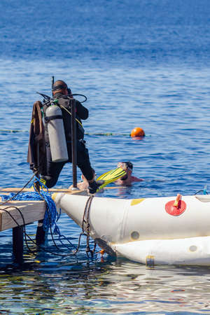 Sharm El Sheikh, Egypt May 10, 2019: scuba diver in a wetsuit jumps into the water.