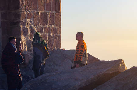 Sinai Peninsula, Egypt, May 9, 2019. Men greet the dawn and take pictures on Mount Moses.