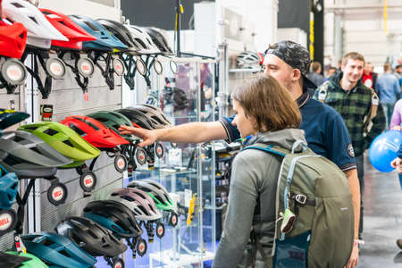 Kyiv, Ukraine, February 28, 2020: buyers choose bicycle helmets at the bike expo 2020.のeditorial素材