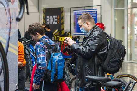 Kyiv, Ukraine, February 28, 2020: A man with a mask on his face to prevent coronavirus disease in the bike shop.のeditorial素材