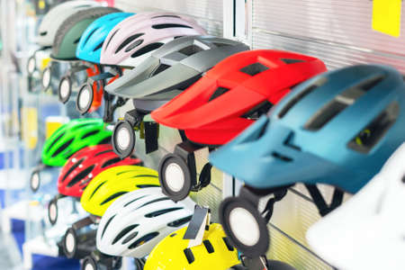 Bicycle helmets on the counter in the bike shop.