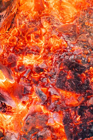 Smoldering charcoal in a bonfire, background texture.