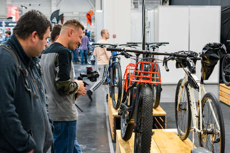 Kyiv, Ukraine, February 28, 2020: man takes pictures on camera in a bicycle store.
