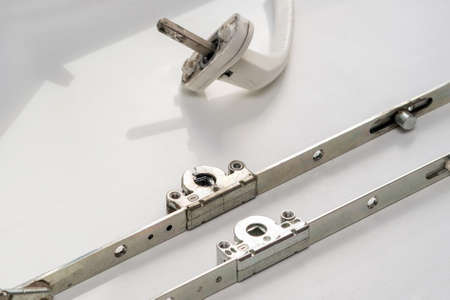Old broken swing-out mechanism of a metal-plastic window.