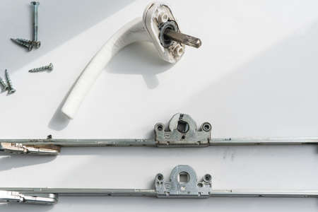 Old broken swing-out mechanism of a metal-plastic window.