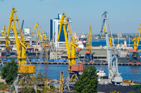 Port cargo crane loads a container onto a cargo ship.