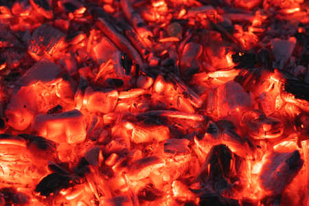 Smoldering charcoal in a bonfire, background texture.