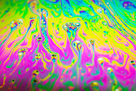 Beautiful psychedelic abstraction formed by light on the surface of a soap bubble.