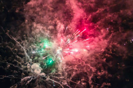 Festive colorful fireworks in the night sky, abstract background.の写真素材