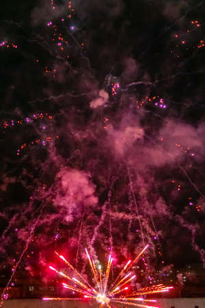 Festive colorful fireworks in the night sky, abstract background.