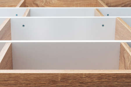 Empty wooden shelving unit with white partitions, background texture.の写真素材