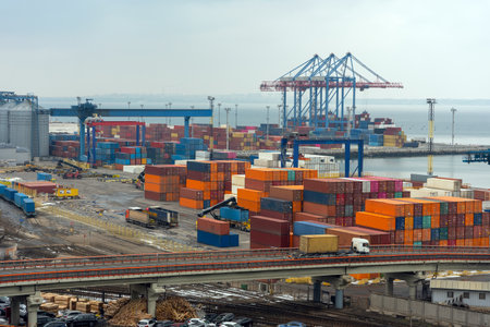 Stacked cargo containers in storage area of freight sea port.