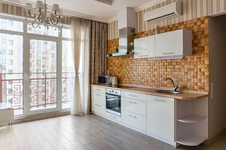 Odessa, Ukraine, February 16, 2021: Modern interior of a bright spacious kitchen with panoramic windows.のeditorial素材
