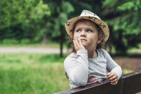 Portrait of a beautiful little girl with a sad look and tear-stained eyes.の写真素材
